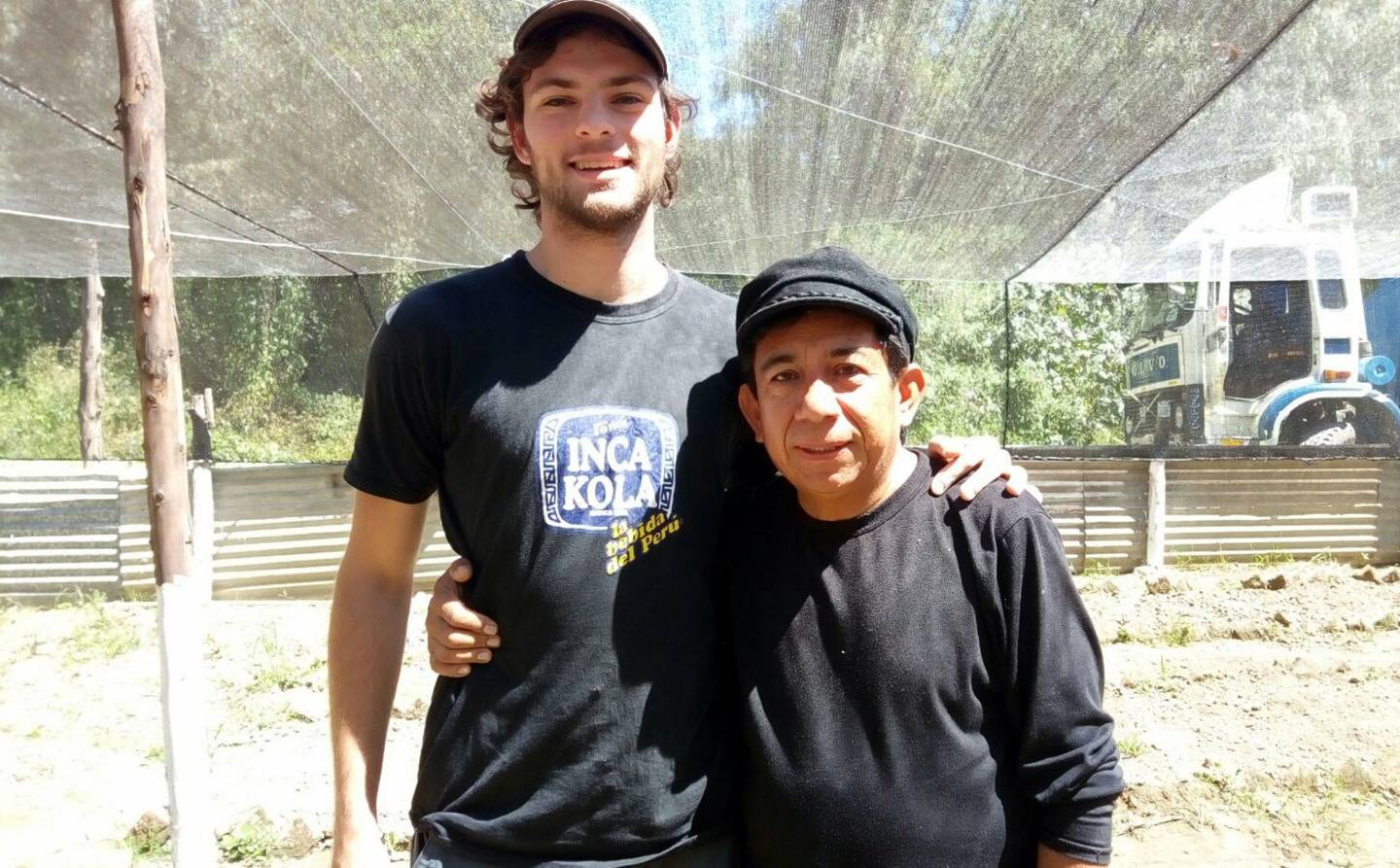 Peter Taylor standing with Oscar Olivera