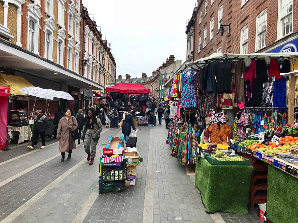 Two women walking through a street market
