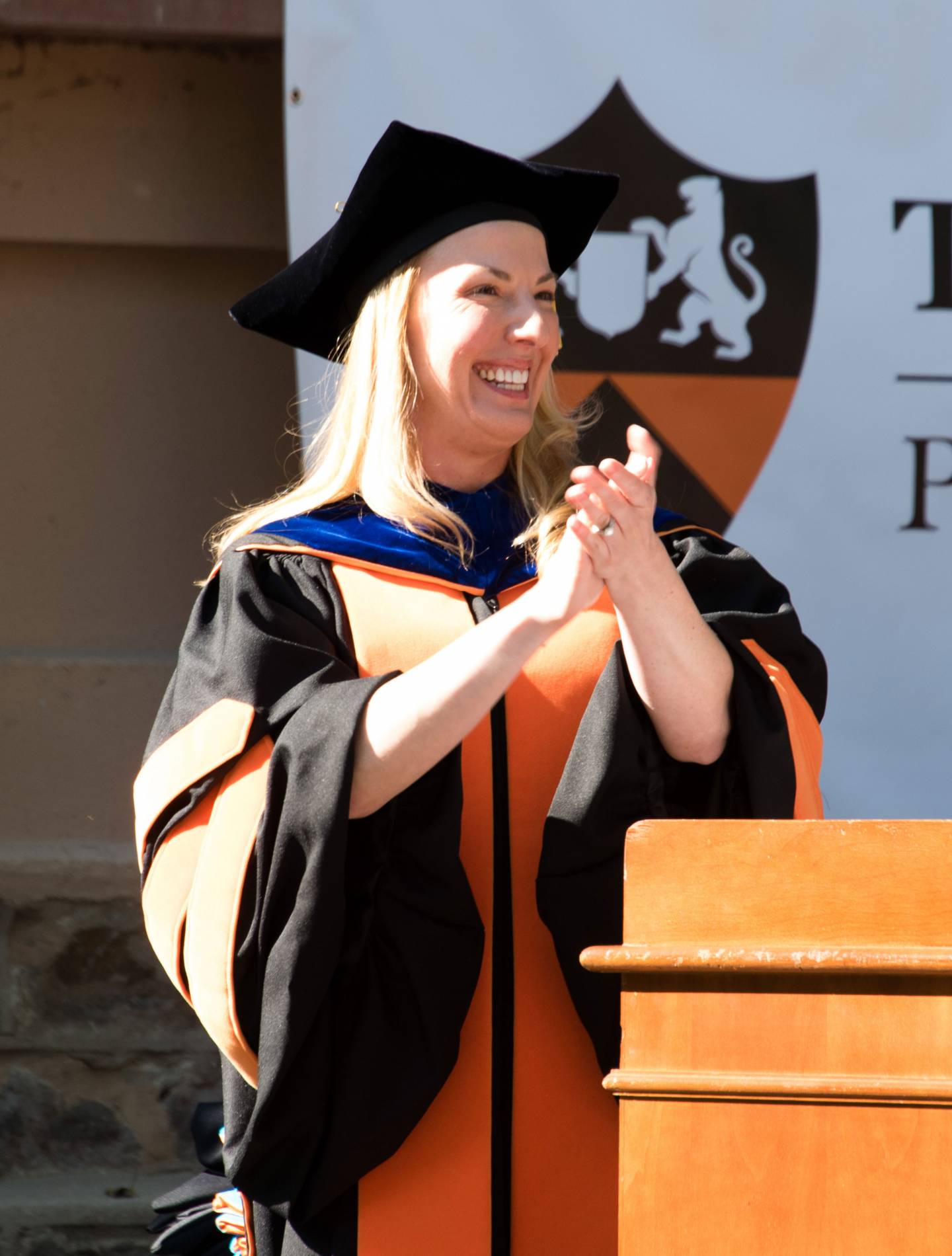 Sarah Jane Leslie clapping at podium