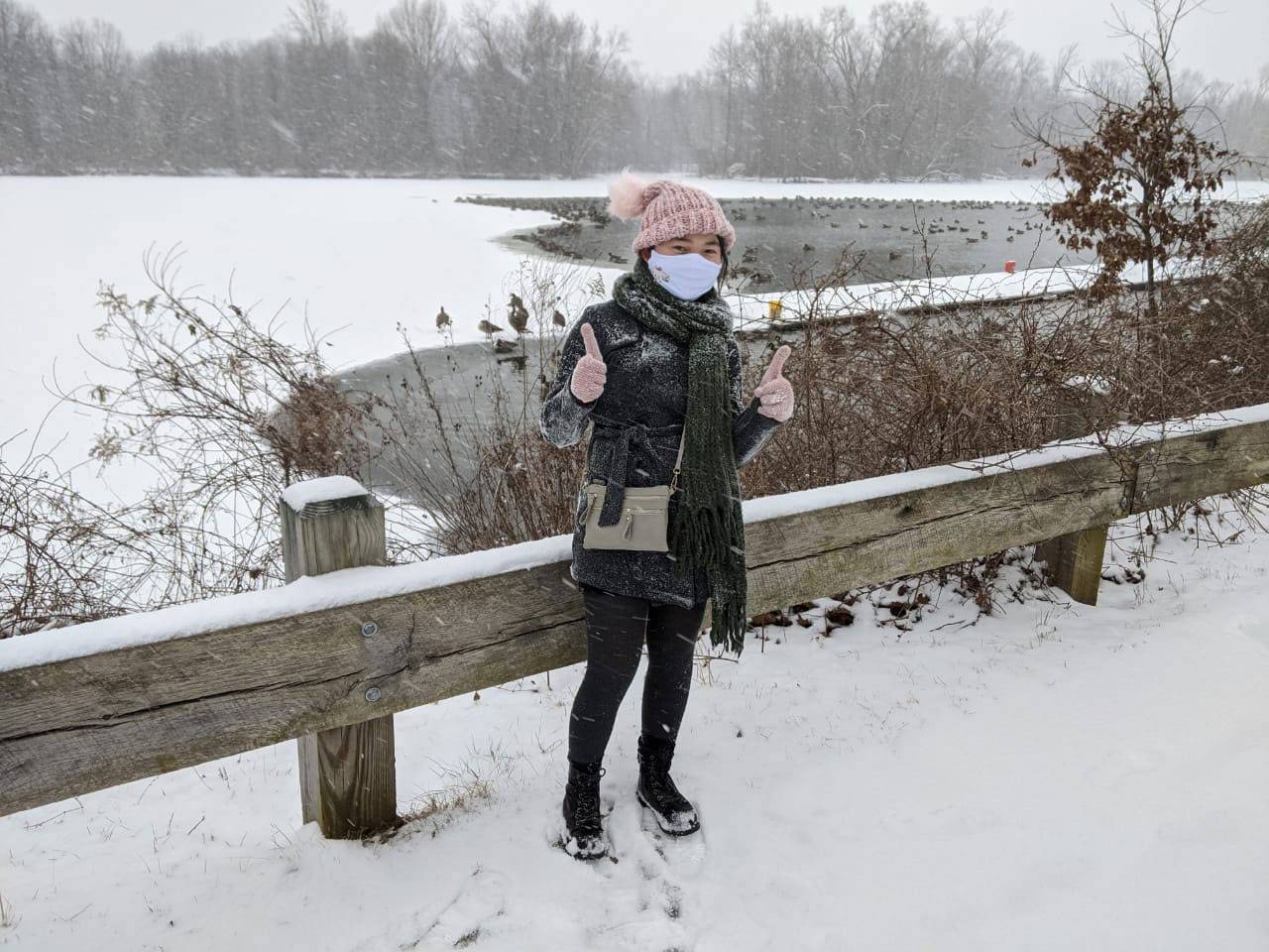 Grace Liu gives thums up in front of a frozen lake