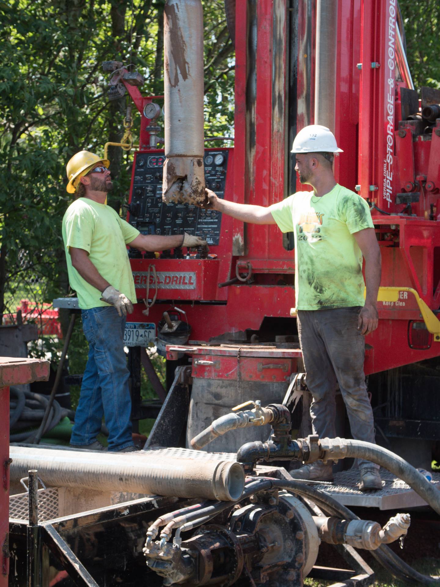 workers supervising the digging of geothermal wells