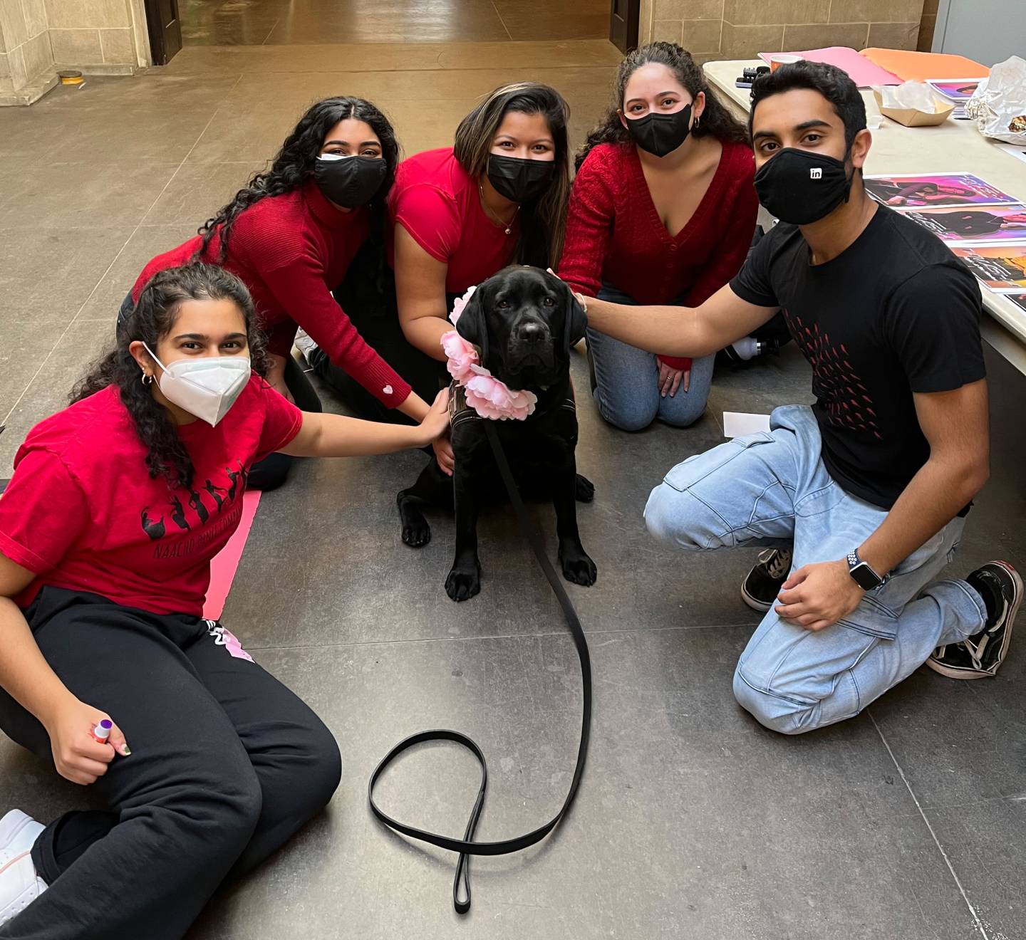 Coach poses with members of Naacho dance troupe