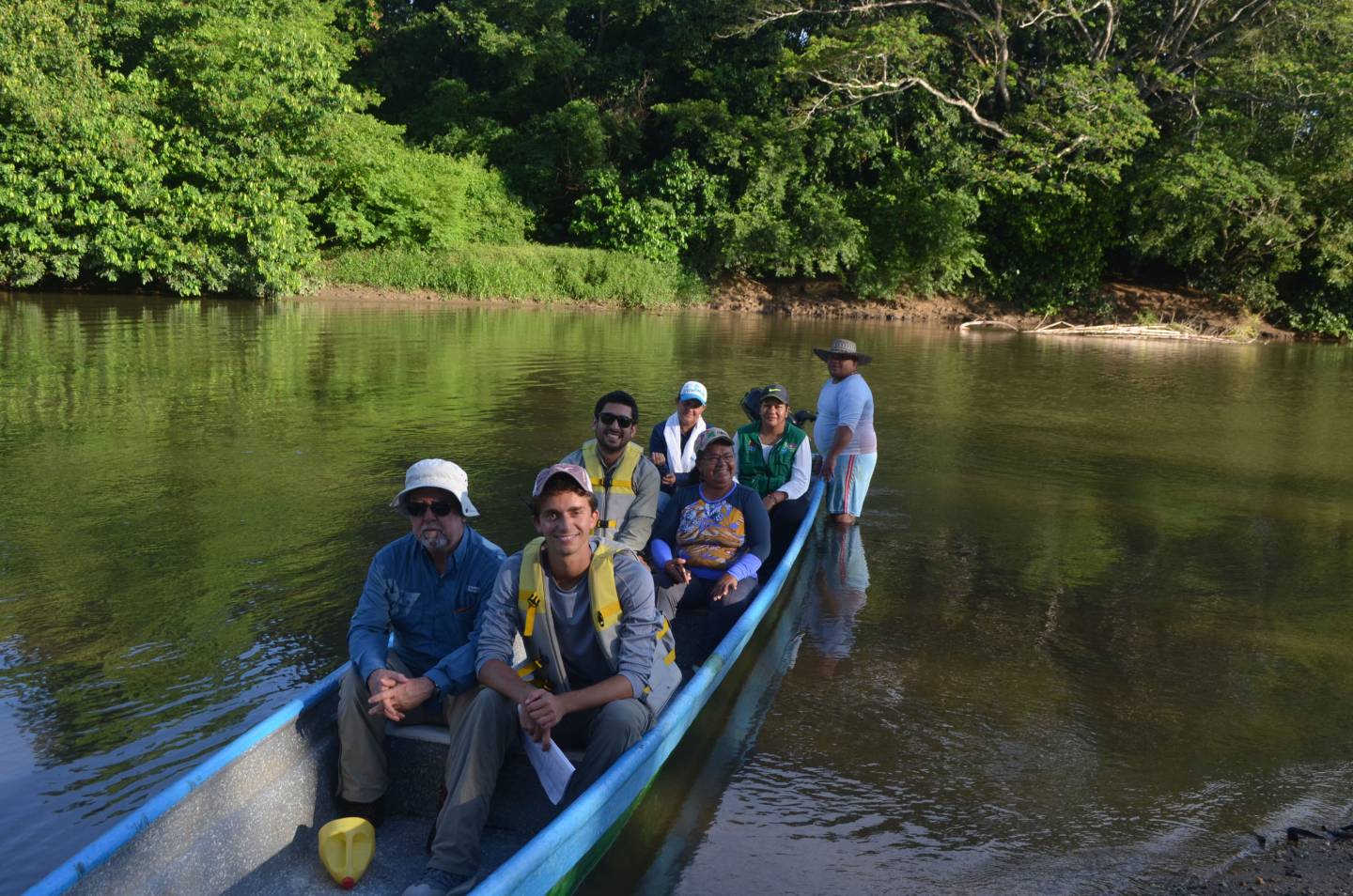 Jordan Salama sits in a canoe with others