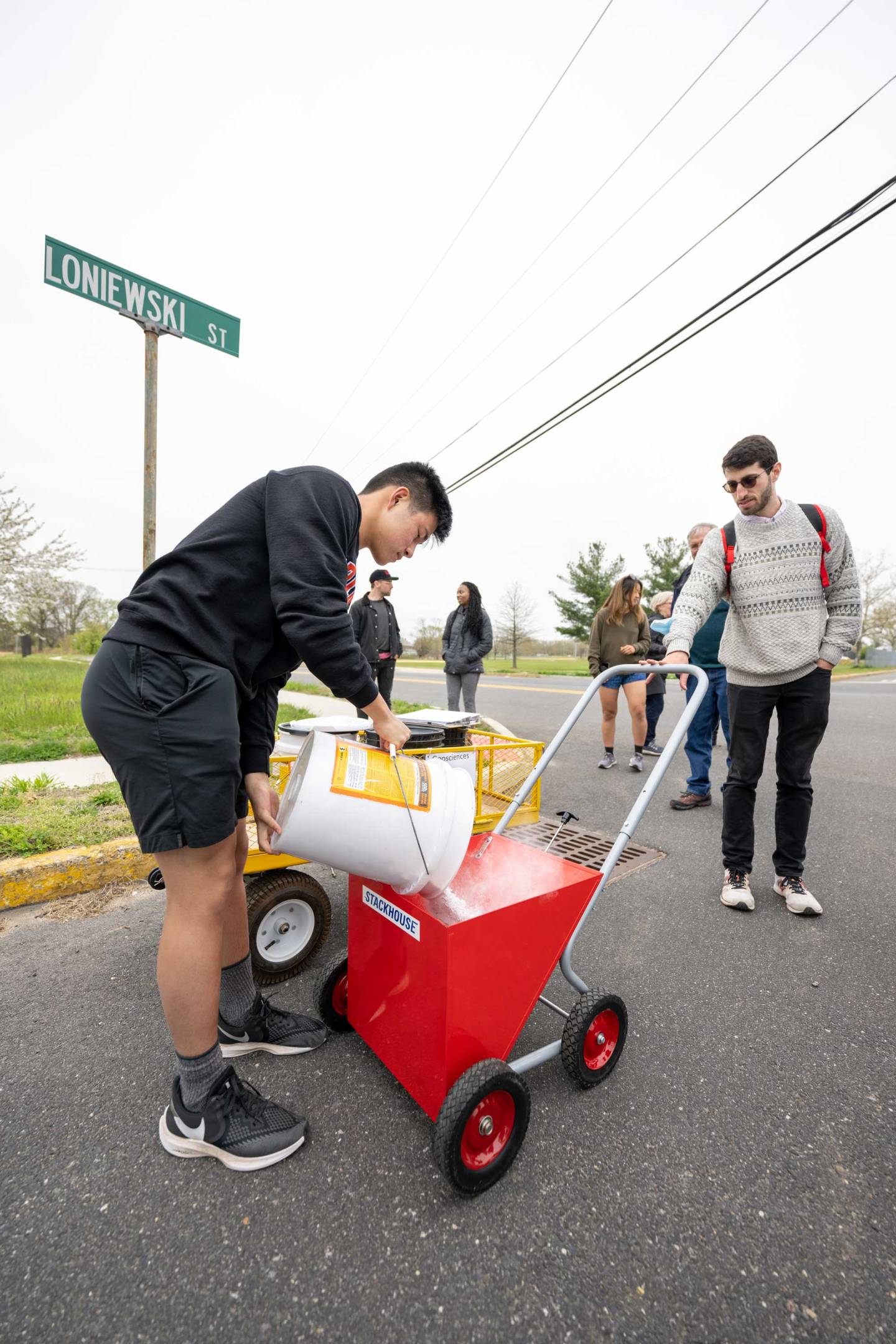 A participant loads the chalk wagon with powdered chalk