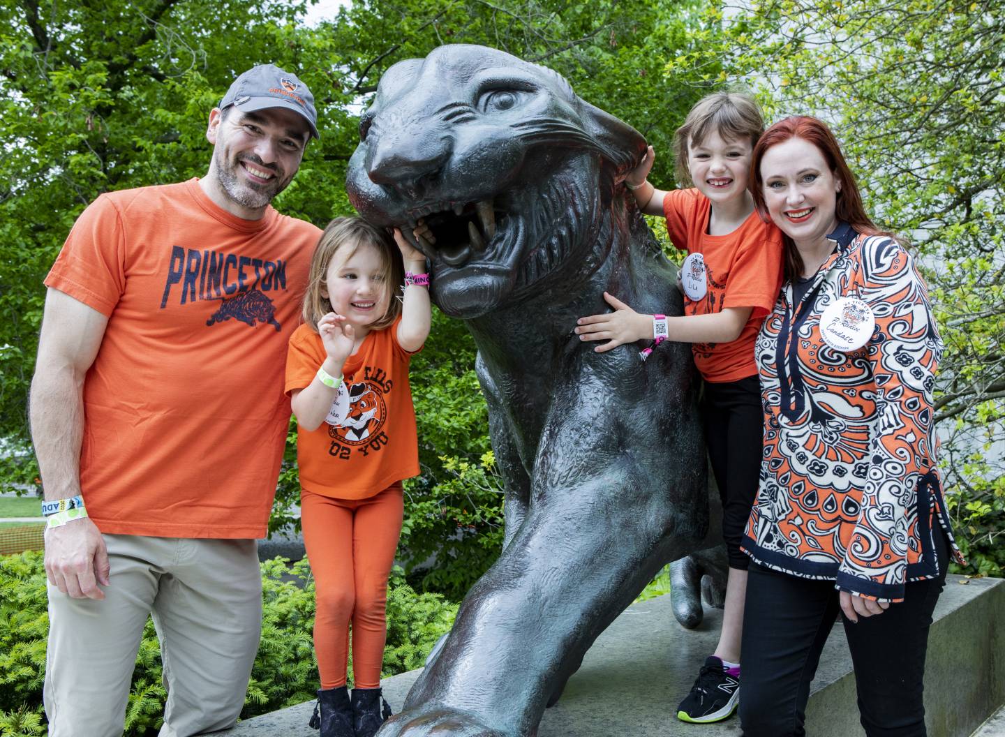 A family flank one of the Whig/Clio tigers