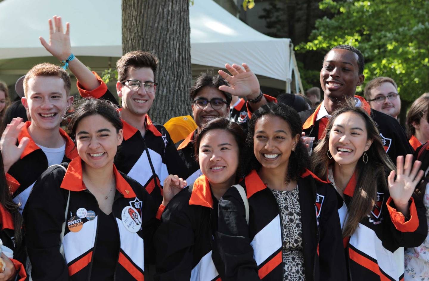 Students wave and smile