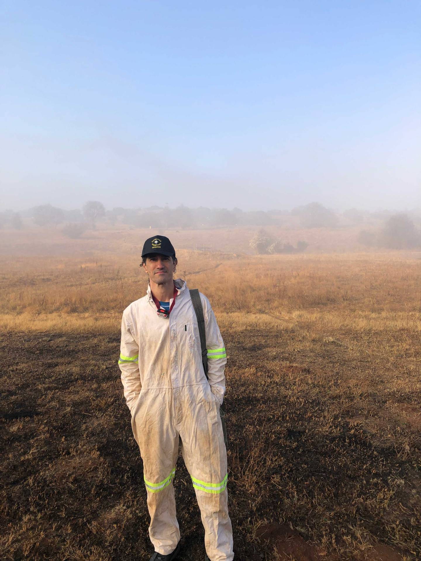 Agustin Fuentes against the landscape above the caves