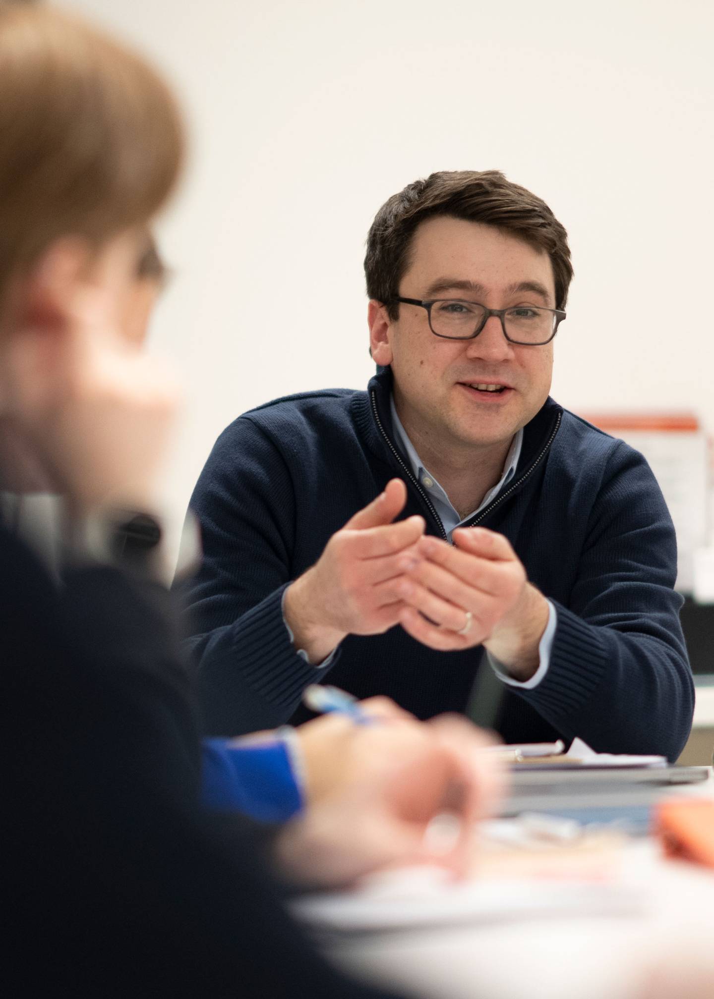 Professor Blaakman gestures to students during a class discussion