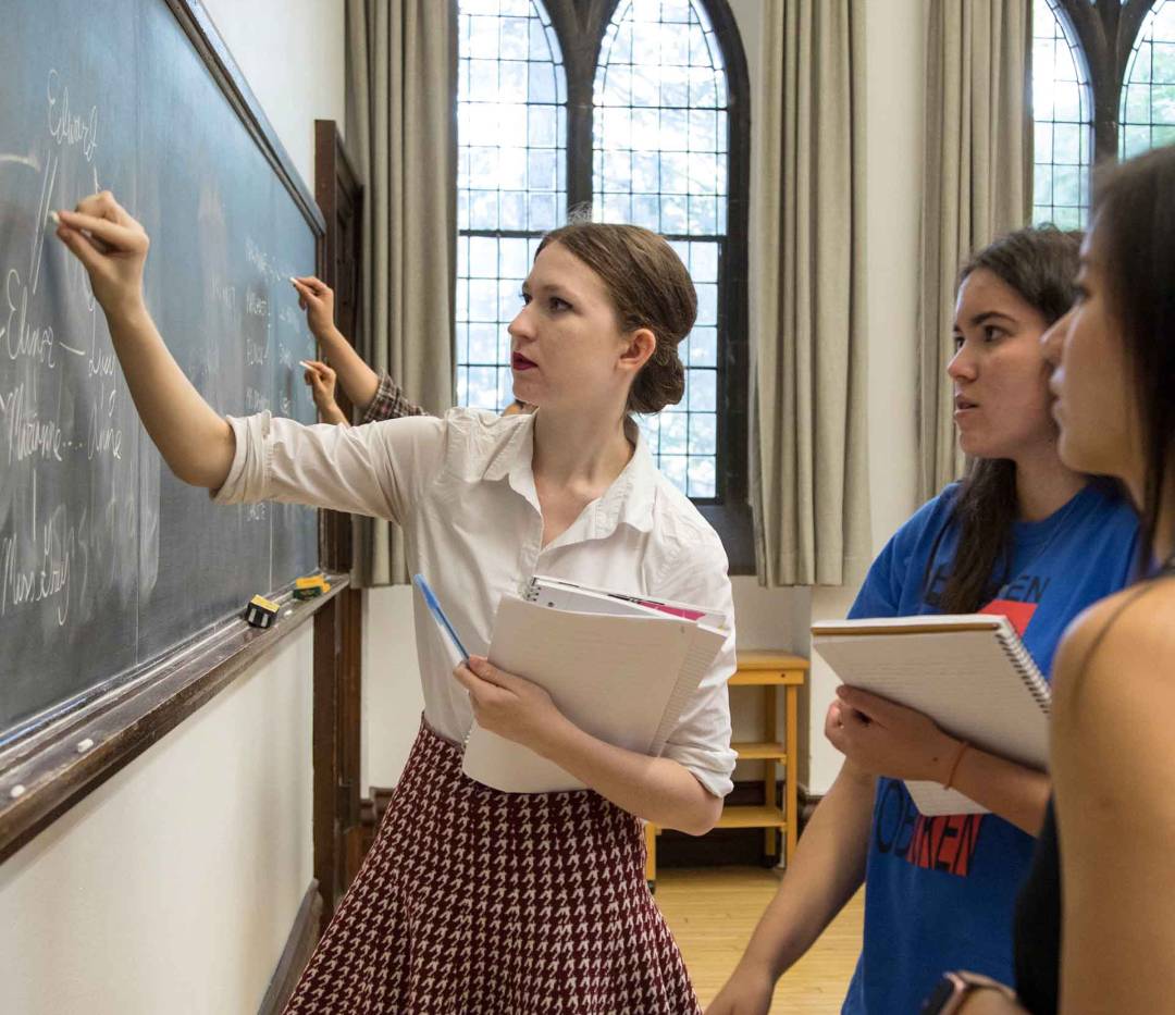 Students writing on the blackboard