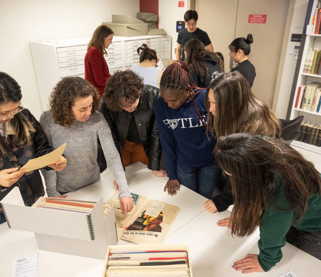 Students examining documents on table