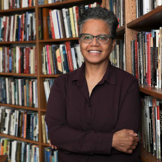 Judith Weisenfeld in front of bookshelves