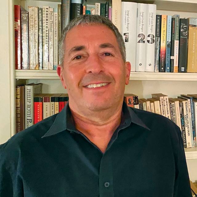 Eldar Shafir in front of bookshelves