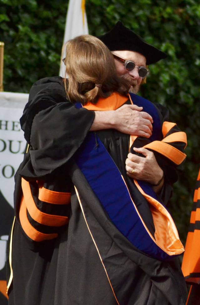 A professor congratulates his student