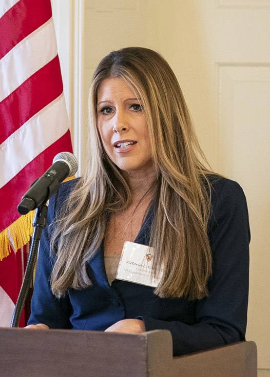 Victoria L. Kuhn presenting at the PTI event from a podium